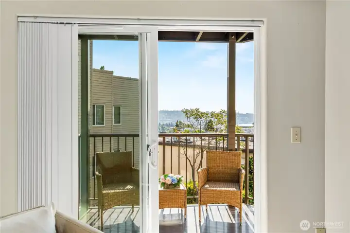 Enjoy breathtaking city views right from your living room, visible through the sliding glass door.