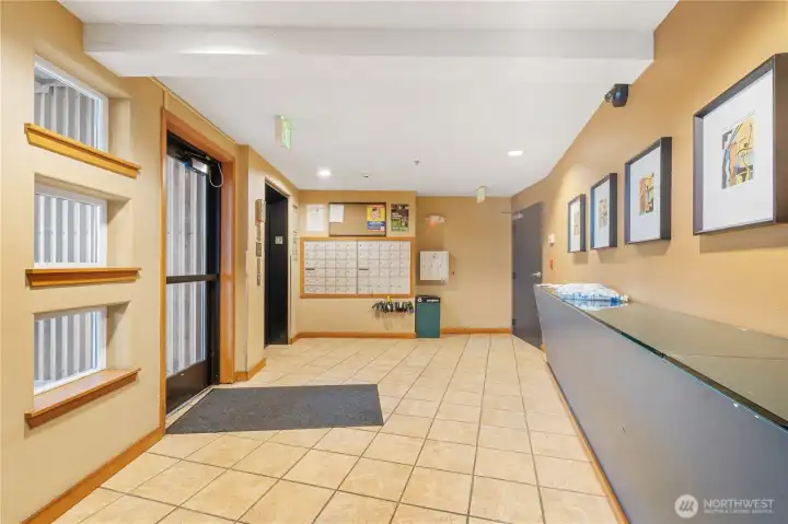 Clean and secure lobby with mailboxes conveniently located near the elevator to the left