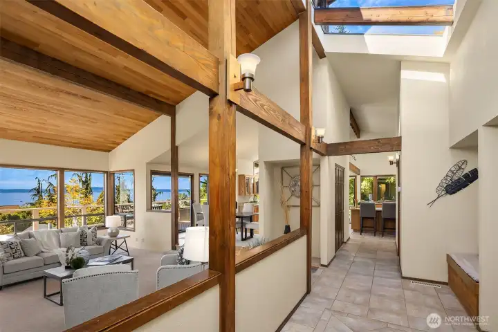 The dramatic entry immediately impresses with soaring ceilings, clerestory windows, and skylights. Architectural details and abundant natural light help showcase the panoramic views of Puget Sound and the Olympic Mountains.