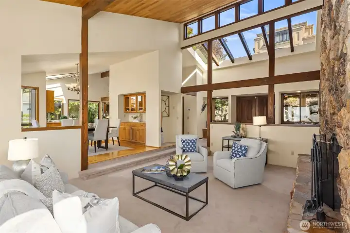 Looking back toward the front door, the dramatic skylights and clerestory windows fill the space with light, creating a bright and airy feel. The dining room features a convenient butler’s pantry with additional storage.