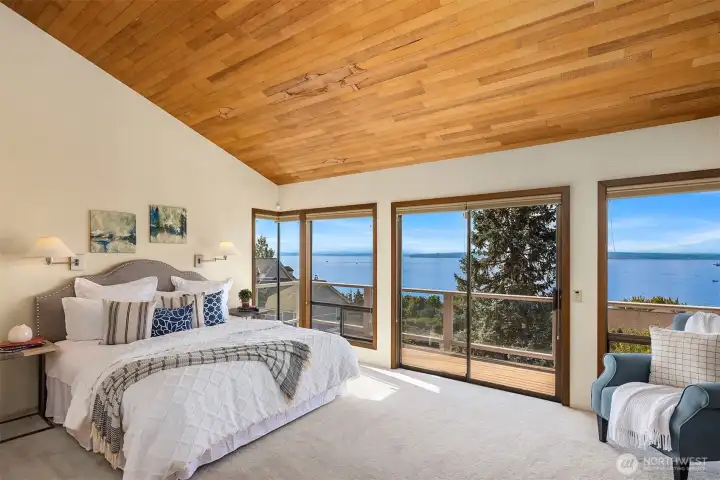 The upper level is dedicated to the primary suite, featuring vaulted ceilings and a private deck with the home’s best views—creating a peaceful retreat.
