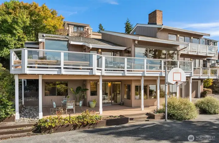 Another view of the back of the home showcasing its expansive decks and thoughtfully designed west-facing orientation.
