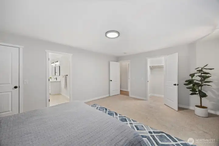 Primary bedroom with two closets & ensuite bathroom