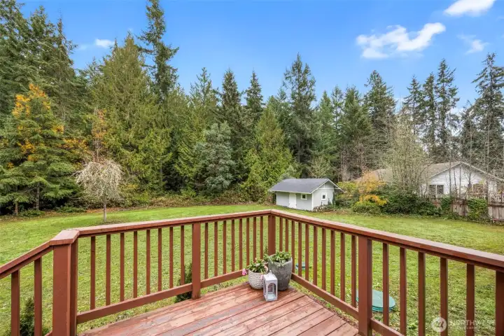 Porch overlooks property and shed