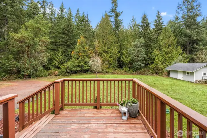 Porch overlooks property and shed