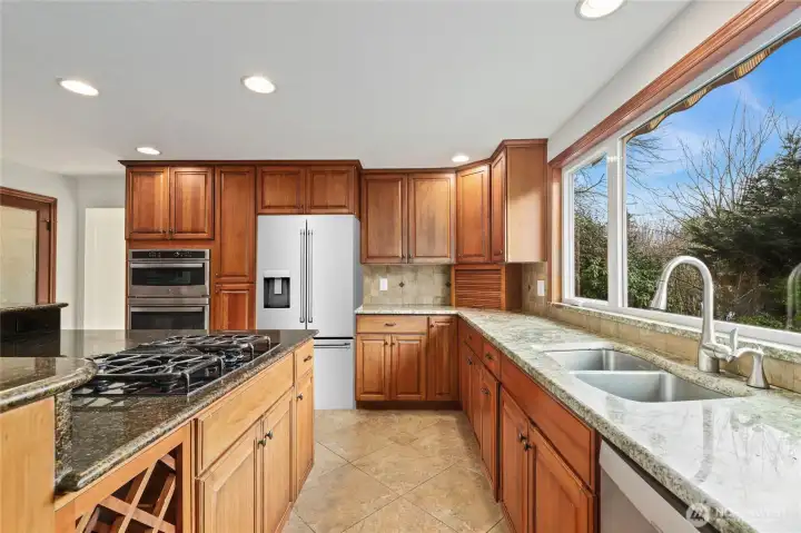 Gas cooking and granite countertops highlight the kitchen. Image is virtually staged for visualization purposes. AI refrigerator does not stay.