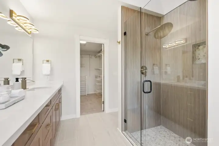 Beautiful spa-inspired primary bathroom with dual shower heads, large walk-in closet, all new fixtures and features throughout.