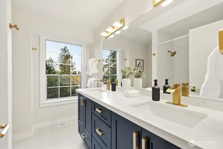 All new bathrooms with quality tile floor, upscale navy vanity with chunky gold handles and fixtures, new tub and toilet - Fresh and ready for you!