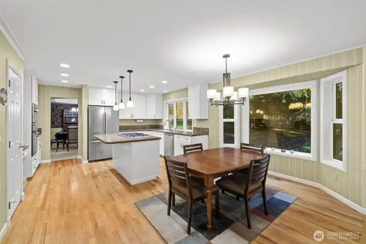 Kitchen with eating space, flows into family room.