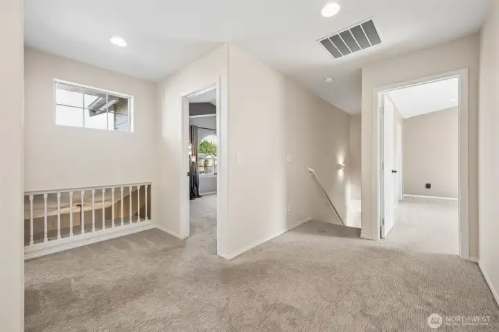 Upstairs features convenient laundry room, guest bathroom, and spacious bedrooms.