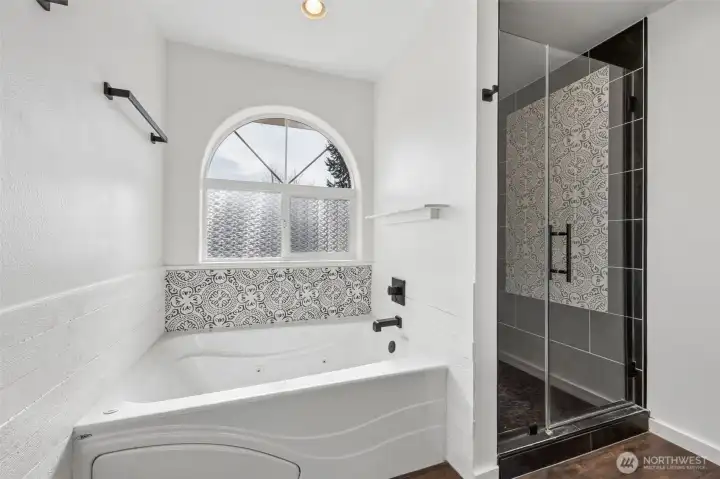 Remodeled primary bathroom with jetted soaking tub.
