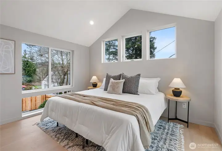 Gorgeous primary suite with vaulted ceilings and tons of natural light.