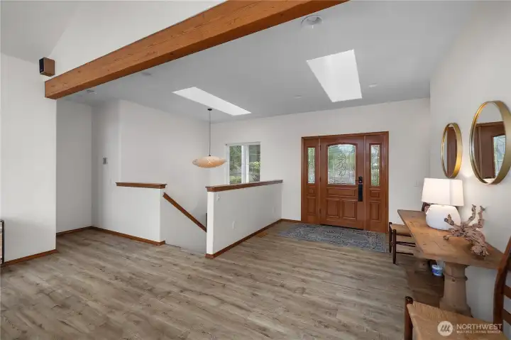 Entry way with a wide wood door, greet your guests in style.