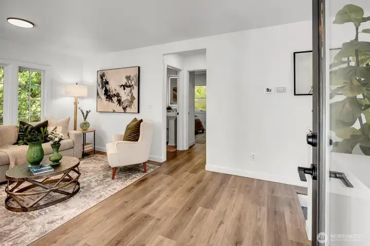 Step through the front door into a welcoming living room, highlighted by new luxury flooring and updated designer lighting throughout the main level.