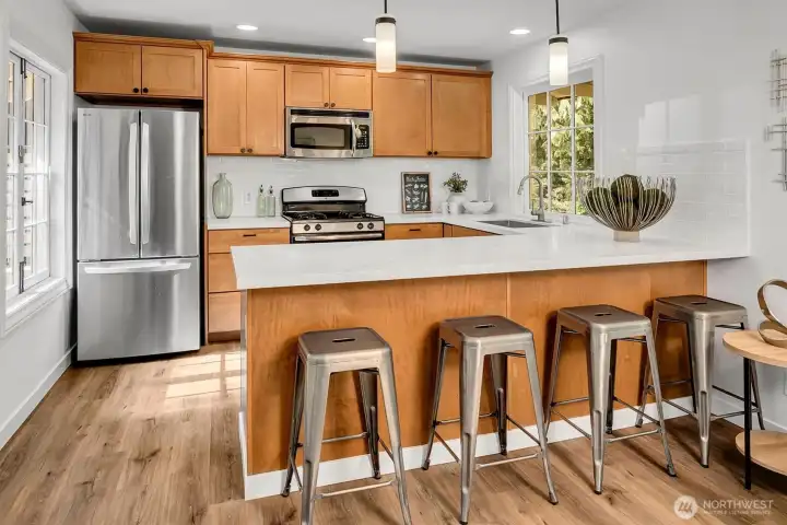 Functional kitchen with built-in counter seating and fabulous, new quartz countertops.