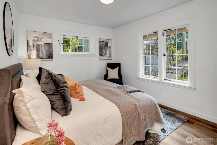 Main floor bedroom with charming, light-filled windows.