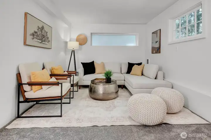 Roomy recreation room located in the daylight basement, ideal for entertaining, media, or flexible living space.