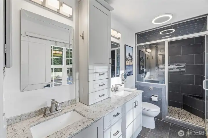 Elegant primary bath with custom tile and dual sinks. Elegant primary bath with custom tile and dual sinks.