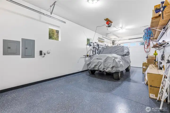 Roomy garage with space for vehicles, gear, and projects. Roomy garage with space for vehicles, gear, and projects.