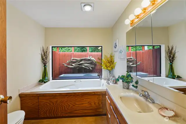 Private bathroom with jetted tub and loads of light