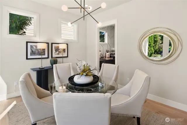 The Formal Dining room located at the North West Corner of the home.  In this picture you can see the Clear strory windows and the doorway to the butlers pantry which leads to the kitchen.