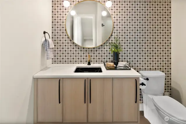 This stunning Powder Bath, conveniently located on the main level, offers both style and practicality with abundant cabinet storage space, making it as functional as it is beautiful.