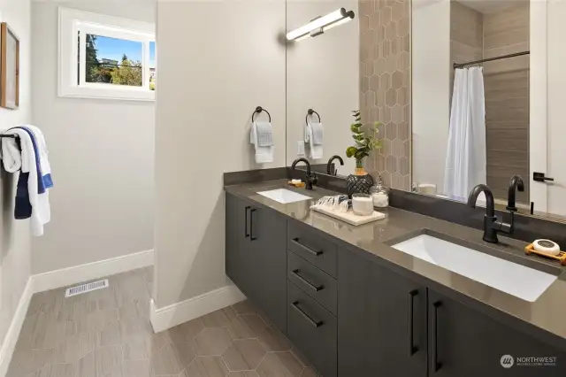 The 2nd-floor Hall Bath is a stunning retreat, featuring double sinks, a tub/shower combination, and a private toilet area for added convenience. Elegant tile floors, floating cabinets, and sleek granite countertops elevate the space, making it both stylish and functional.