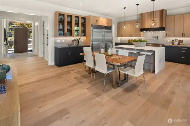 The Kitchen with dining area with the front door entrance to the left.