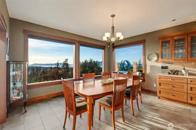 The dining area is surrounded by oversized windows that capture panoramic views of the islands and waterways beyond.