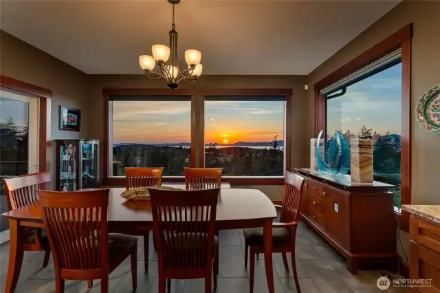 The dining area offers a front-row seat to spectacular sunsets, with panoramic windows perfectly framing the vibrant evening skies.