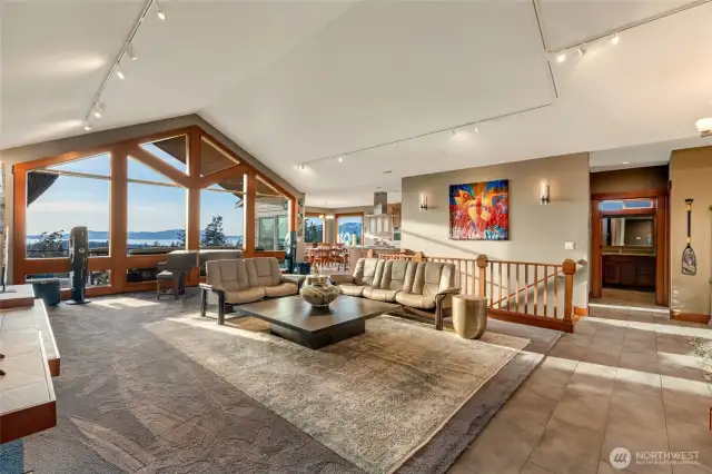 Modern ceiling-mounted track lighting enhances the architectural details and offers customizable illumination throughout the living space.