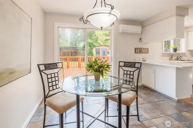 Dining Area with kitchen to the right and slider to back yard and deck.