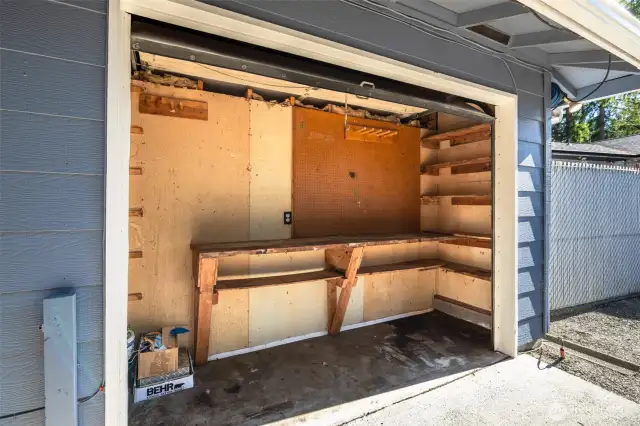 Tool/storage workshop area inside garage door. About 3 feet deep.
