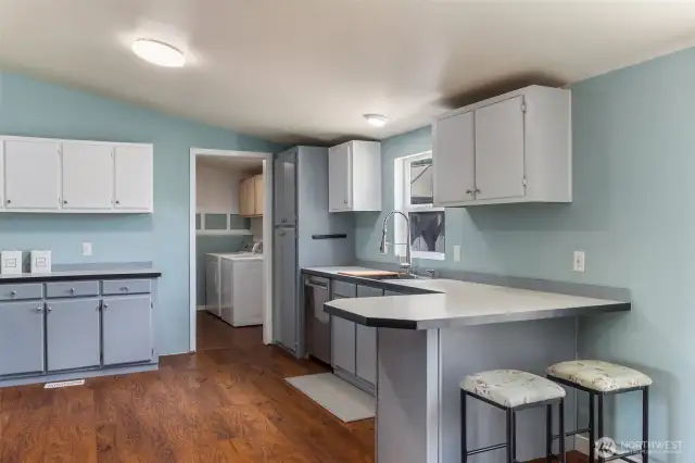 View of the kitchen with new appliances and deep farm sink.