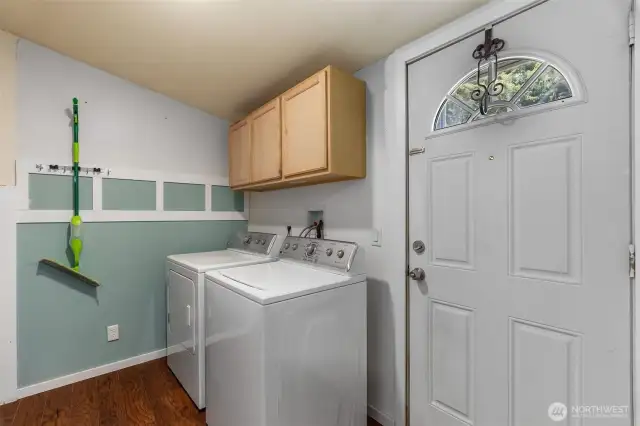 Laundry room with additional cabinets for storage.