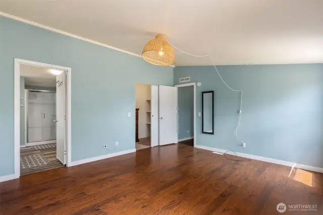 View of primary bedroom into ensuite with walk in shower and bidet.