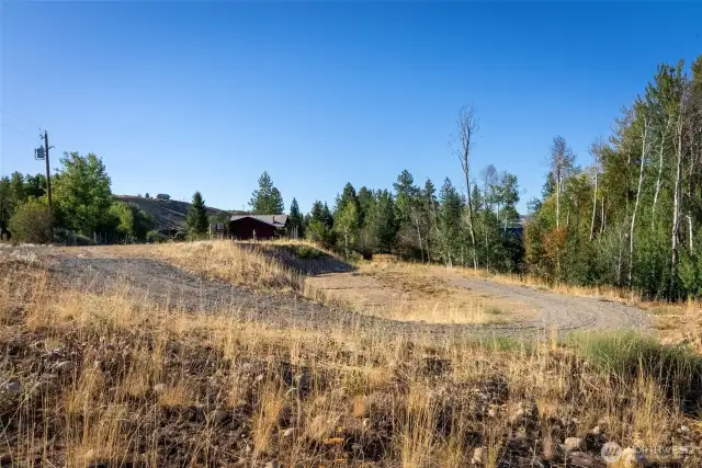 Spacious lot offering mountain glimpses through the trees.