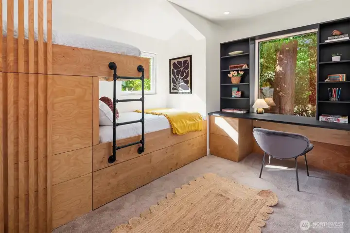 Darling bunk room with custom built in desk and two bunks. Hidden cubby and closet, too.