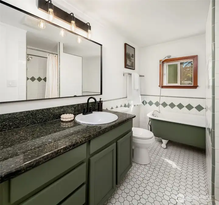 Sweet claw-foot tub and separate tiled shower in the bath.