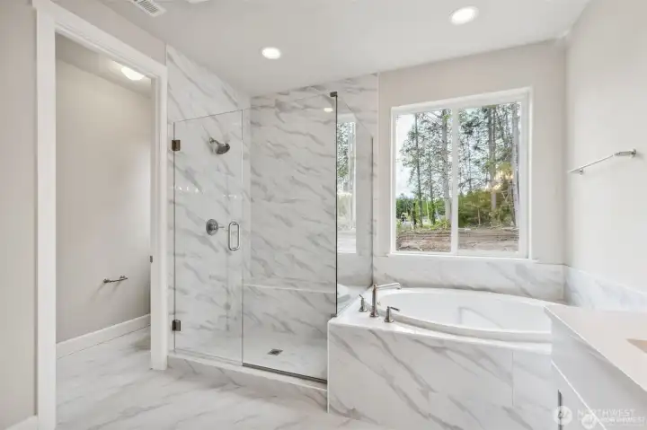 Deluxe Primary Bathroom on the Main Floor. All photos are of other Hastings in the community. Finishes can vary.