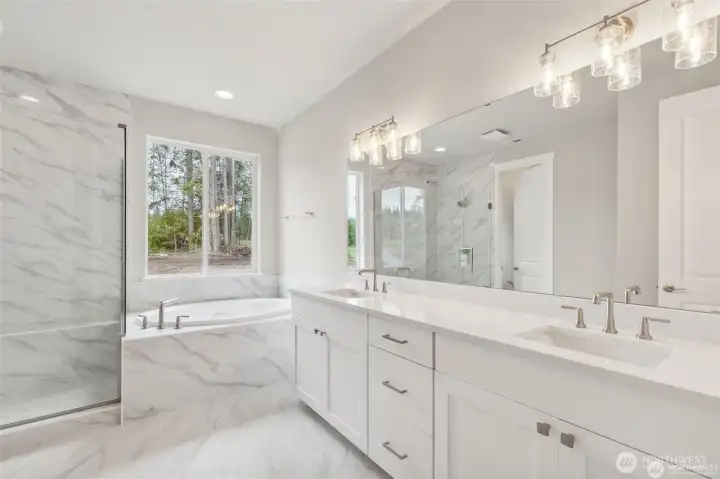 Deluxe Primary Bathroom on the Main Floor. All photos are of other Hastings in the community. Finishes can vary.