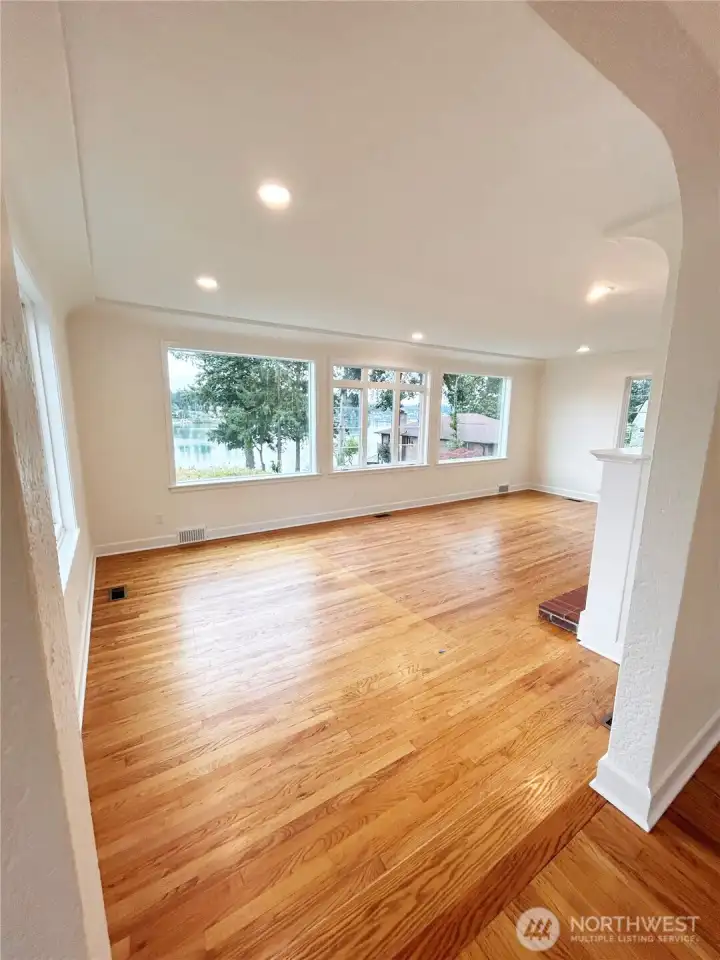 Coved ceiling, oak hardwood floors in welcoming living room. The Olympic mountains can be seen from this room on clear days, what a treat!