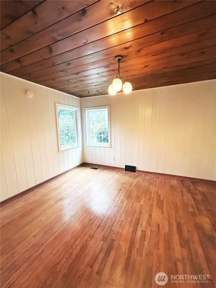 Oak hardwood floors and garden views from main floor bedroom
