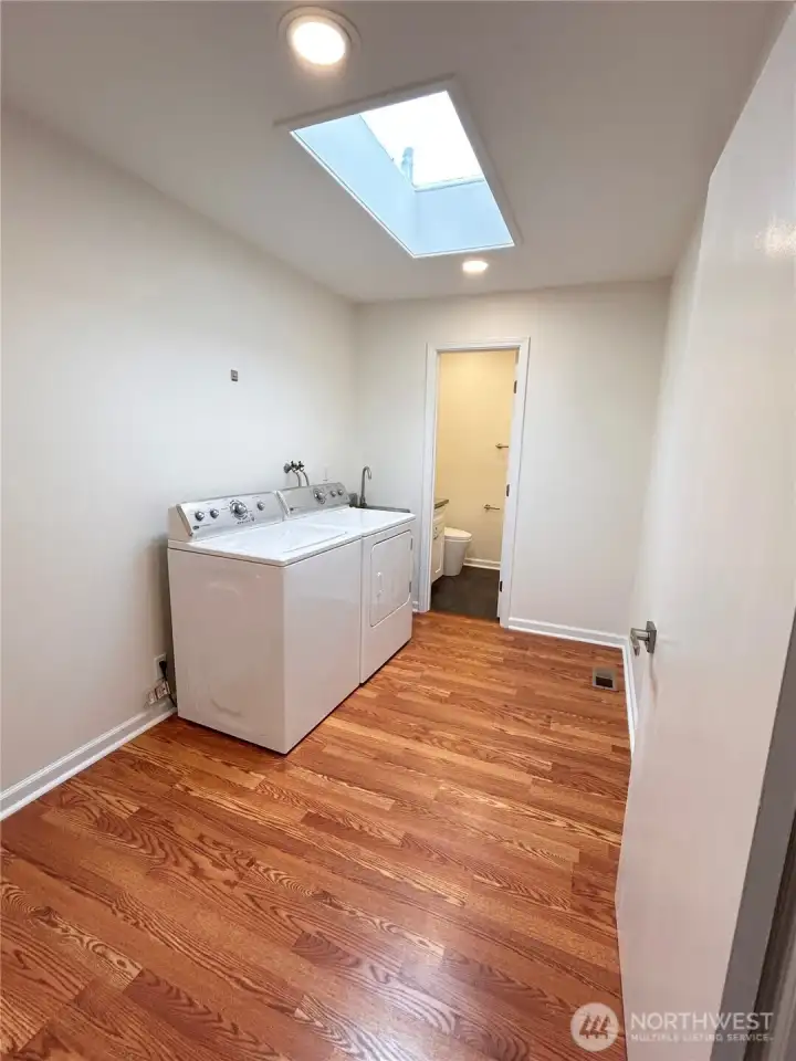 Spacious mudroom with utility sink, access to 2 car garage