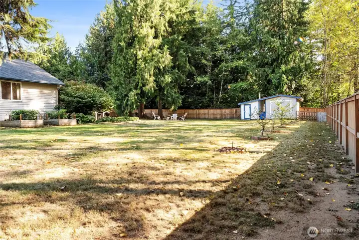 Raised garden beds on the left get a ton of sunshine! Property backs up to greenspace, so this backyard is perfectly private!