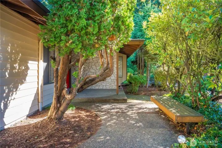 Corner lot has mature landscaping and a lot of privacy. The front patio is perfect for enjoying a cup of coffee and watching your neighborhood.