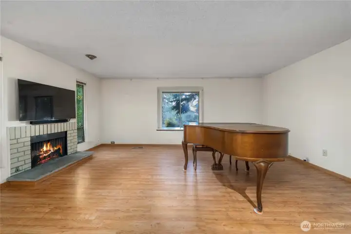 Just off the foyer, the large living room with cozy, wood-burning fireplace invites you into the space.