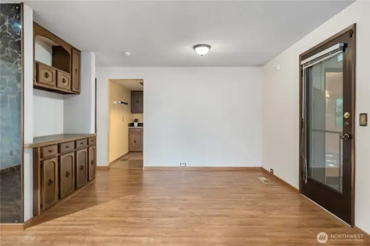 One of two dining areas - both with doors to the patio. Built-in cabinet offers additional storage.