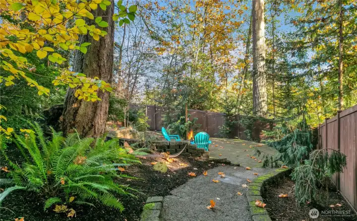 Yes!  A firepit!  And, the fire-bowl stays!  A great space along the winding path for contemplation or s'mores!!