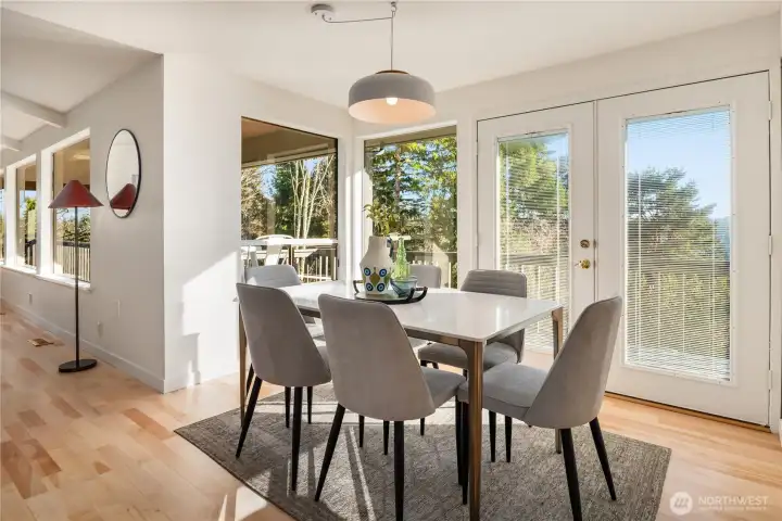 Between the formal living room and kitchen is this formal dining room with french doors that lead out to the full length deck and views of the lake.